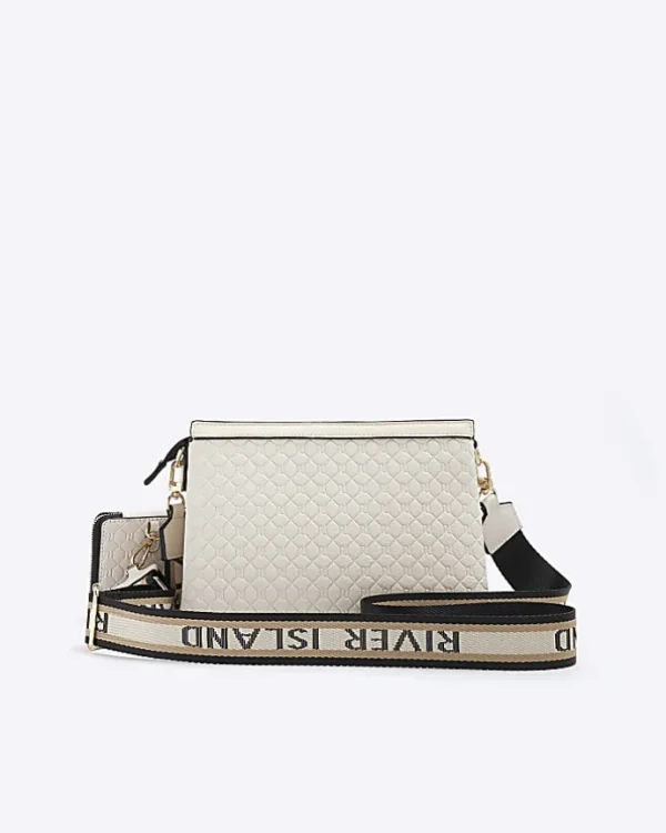 Cream embossed monogram cross body bag