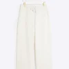 Petite cream textured wide leg trousers